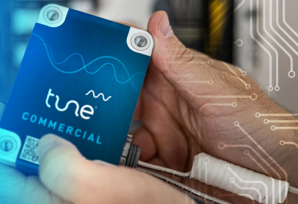Hand holding a Tune Commercial power quality device